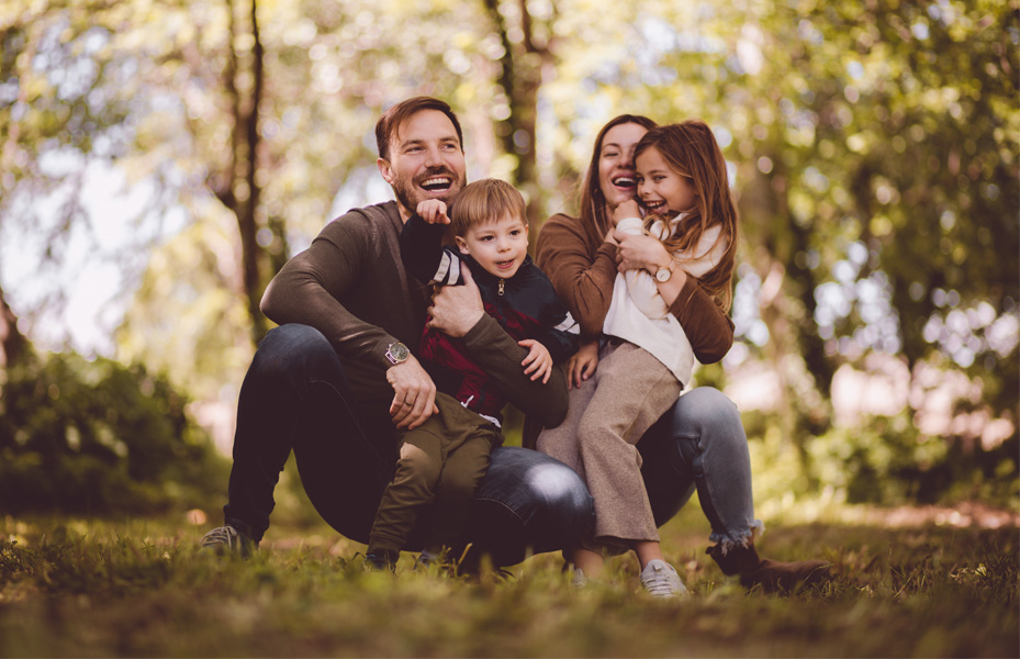 Family hugging outdoors