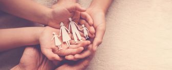 Hand with a family cut out of paper inside